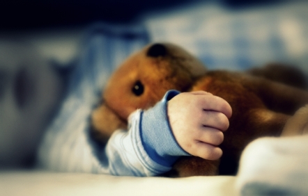 sleeping boy with teddy bear