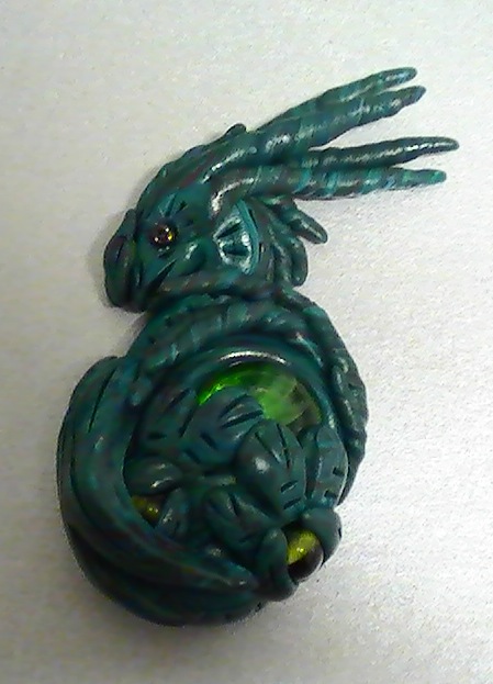 Little Green Dragon Holding Marble