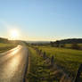 The sun is shining on the countryside.