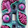 Purple pink and teal monster switchplate