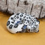 Snow leopard with sodalite gem