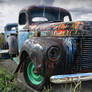 Rusted Trucks at the end of the Road