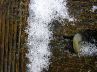 Snow with wood, and a screw.