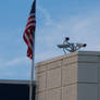 Security Cameras, cloudy sky and American flag