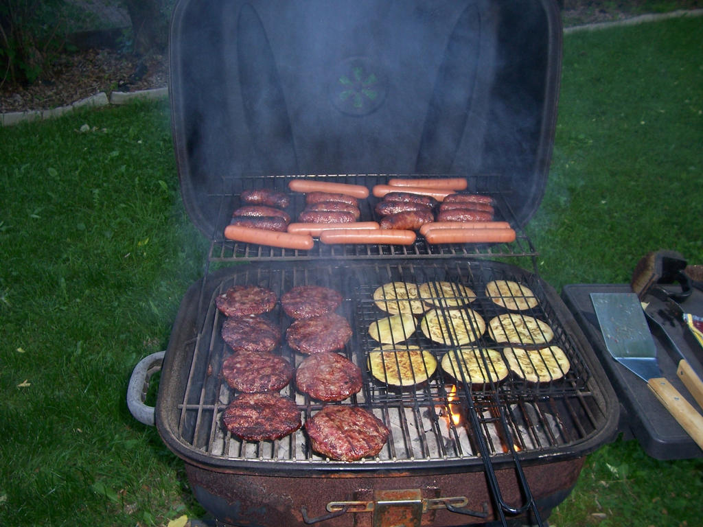 Grilled eggplant, burgers and hotdogs summer day