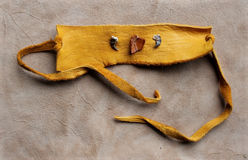 Raccoon claw, wood bead and deerskin bracelet