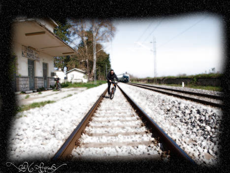 Cyclist on the train tracks.