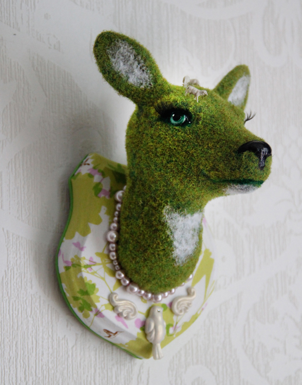 Green gras deer with sheeps