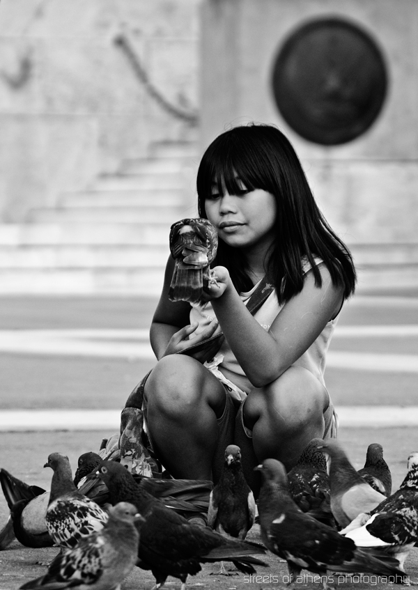 Girl feeding pigeons