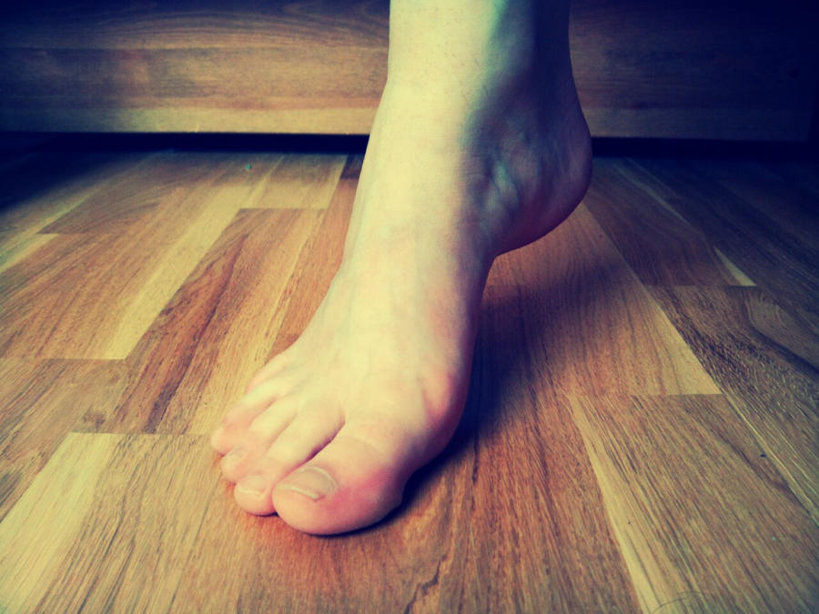 Foot and wooden floor