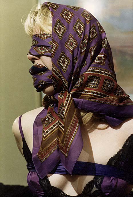Tied and gagged with silk-scarves. elegant dressed and styled ladies, weari...