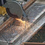 Worker sawing metal beam