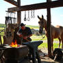 Blacksmith Working At A Forge In An Open-air Works