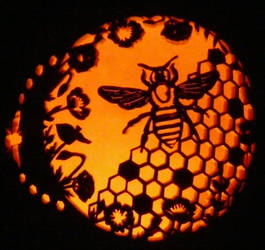 bee and honeycomb hand-carved on a foam pumpkin