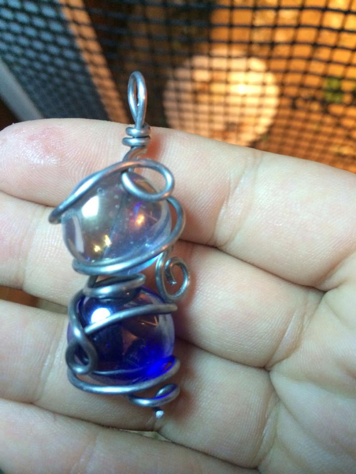 white, blue, and silver pendant