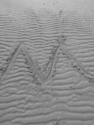 'M' Drawn in Sand