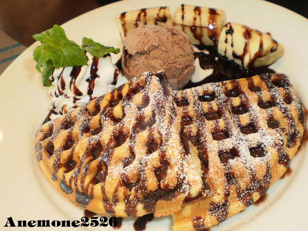 Waffles with Banana and chocolate sauce.