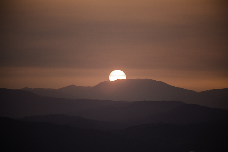 Hazy sunset over distant mountains