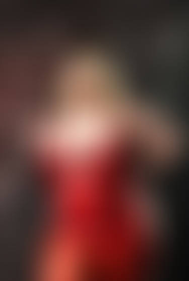 Sexy plus size dominatrix holding a whip