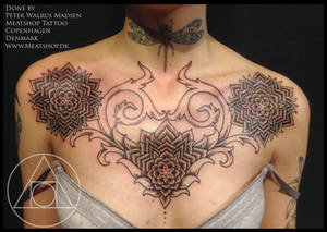 Mandala chestpiece tattoo in black and red