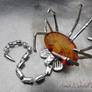 Facehugger silver brooch with amber carving