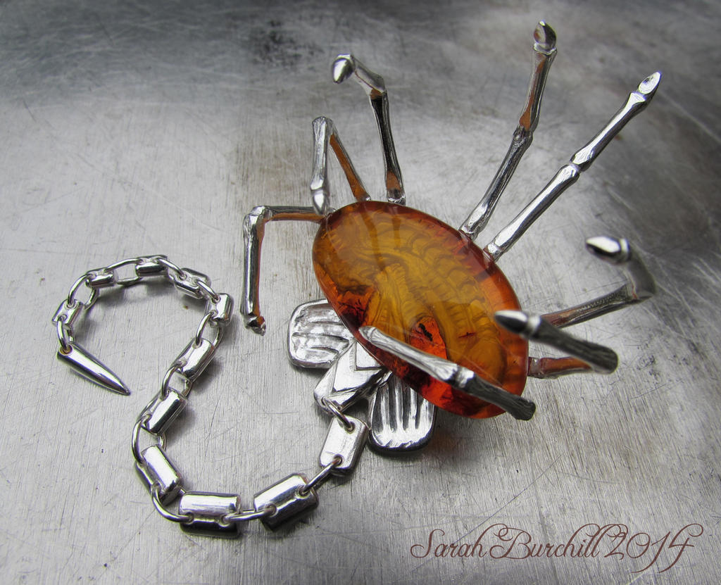 Facehugger silver brooch with amber carving by fairyfrog