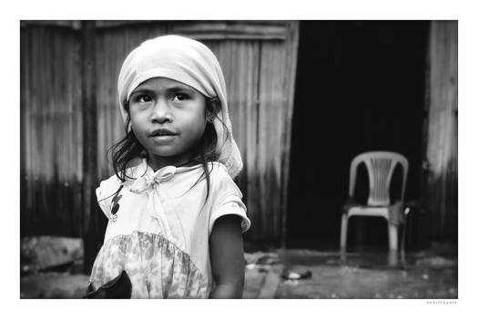 Little girl outside house. Dili, Timor-Leste