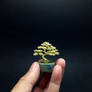 A tiny gold wire bonsai tree by Ken To