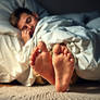 Sleeping man, barefeet.