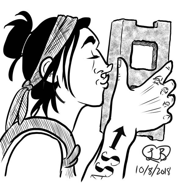 A tattooed white woman with black hair kissing a cinderblock.
