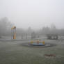 Playground in the frosty fog
