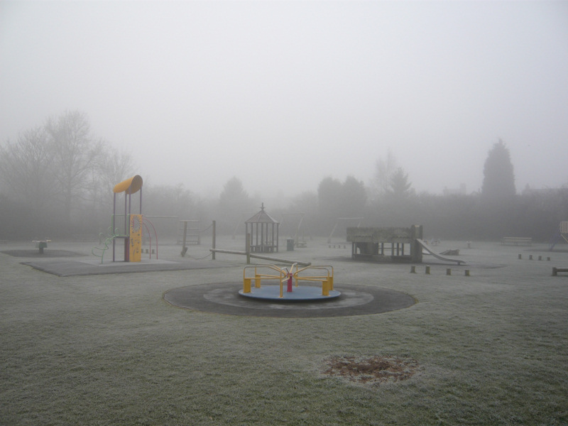 Playground in the frosty fog