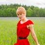 Woman in red in a flowerfield