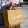 Free Girl Holding Kraft Paper Shopping Bag Mockup