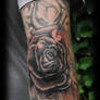 Rose on elbow tattoo