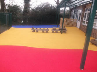 Colourful wetpour play area flooring installation