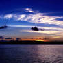 Sunrise seascape blue sky white altostratus cloud.