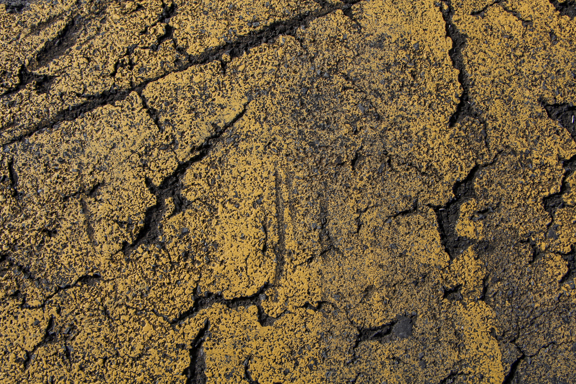 aging yellow paint on pavement