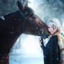 The girl with a horse in the winter forest