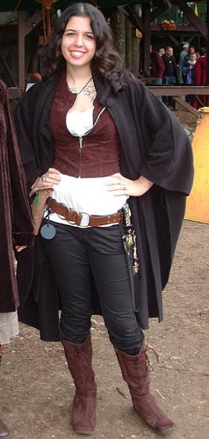 Simple ren faire outfit with white shirt, corseted vest, work pants, boots, and thrifted belt accessories