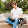 Young-man-working-laptop-park 23-2148205551