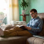 Young-man-with-book-sofa-home 78636-273