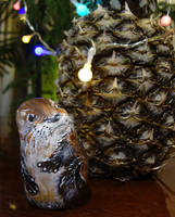 Stone painting: otter found a pineapple with light