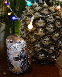 Stone painting: otter found a pineapple with light