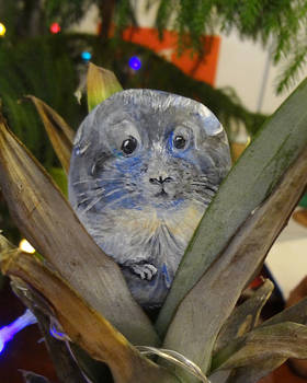 Rock painting: hamster hides in bushes