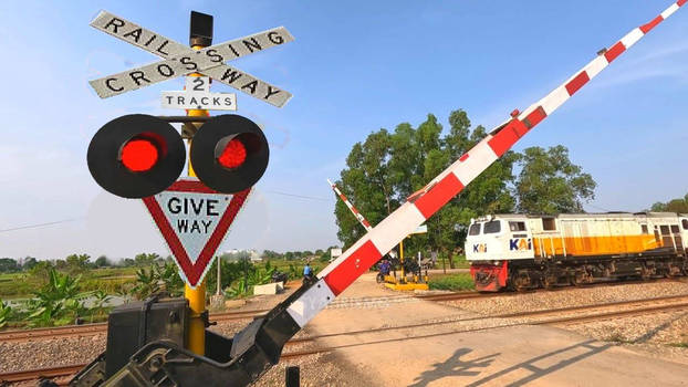 KAI locomotive passing Aussie crossing signs