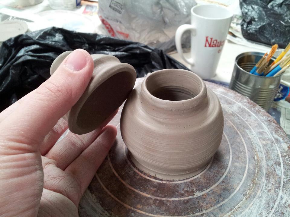 small ceramic pot, taking the lid off