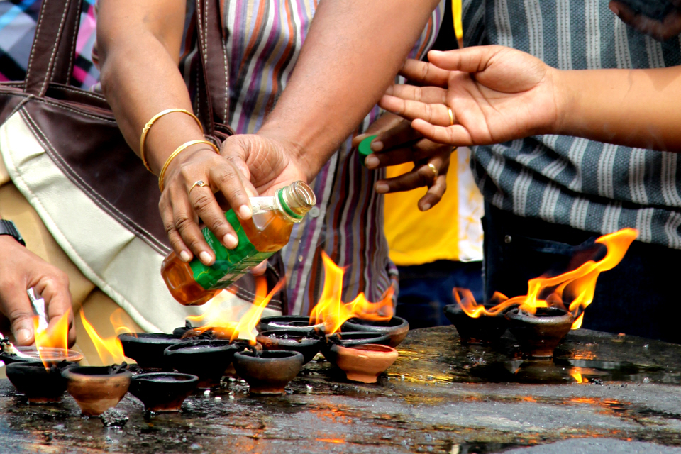 Lighting oil lamps, Sri Lanka.