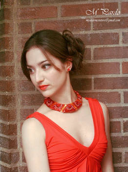 Bead embroidery neck piece in red and orange tones