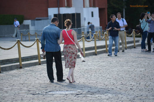 Barefoot girl walking in street whith dirty feet